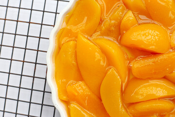Sliced peaches in syrup served in a bowl