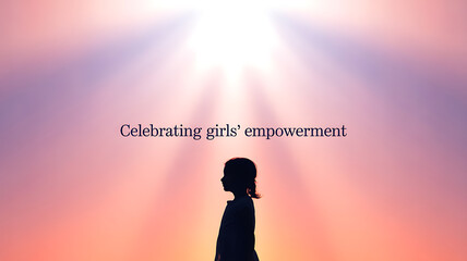 Fototapeta premium Silhouette of a girl standing against a radiant sky, symbolizing empowerment and inspiration.