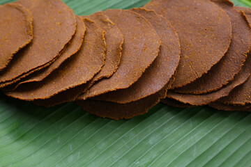 Fermented soybean discs, known as “Thua Nao,” a traditional Thai seasoning used to enhance flavor in Northern cuisine.