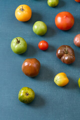 Variety of heirloom tomatoes on blue background
