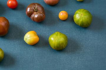 Variety of heirloom tomatoes on blue background
