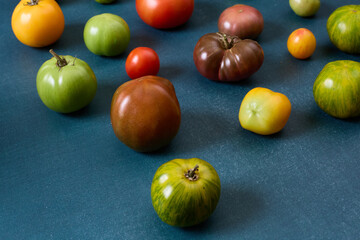 Variety of heirloom tomatoes on blue background
