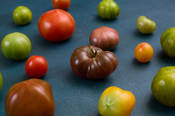 Variety of heirloom tomatoes on blue background

