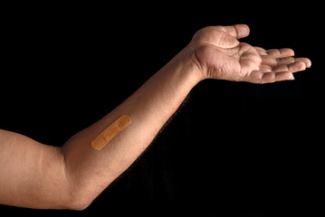 Close-Up of Bandage on an Arm with Dark Background