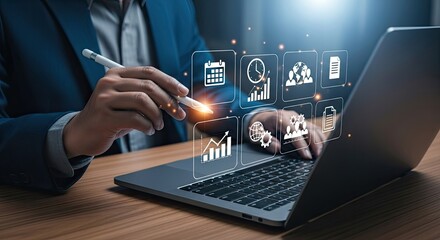 Fototapeta premium DarkSkinned Man Touching Glowing Business Icons with Stylus on Laptop Computer