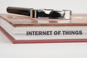 The concept of technology and development. Phrase, words, text INTERNET OF THINGS on the end of the book, a close-up front view