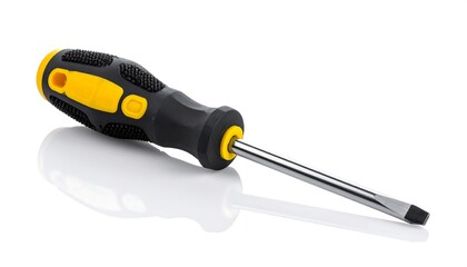 A flathead screwdriver with a yellow and black ergonomic handle rests on a reflective white surface