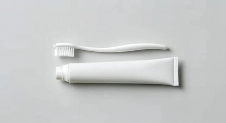 Minimalist white toothbrush and toothpaste on a light gray background
