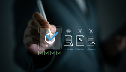 ISO certification review and quality management concept with hand holding digital pen checking completed task. Quality assurance, compliance, standardization, audit readiness and process verification.