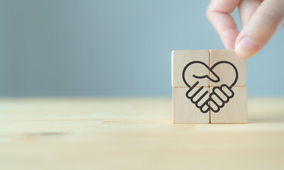 Empathy in leadership concept. Wooden block symbolizing trust, empathy and partnership representing...