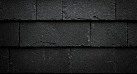 Dark textured slate roof tiles provide a natural, modern building material backdrop.