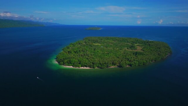 Yuo Island fishing boat remote pristine untouched tropical Mushi island coastline village Wewak Madang Cape Wom Papua New Guinea aerial drone PNG dry season summer morning blue sky circle left