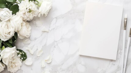 Elegant White Flower Bouquet with Roses and Petals Next to Blank Notebook and Pens on Marble Surface