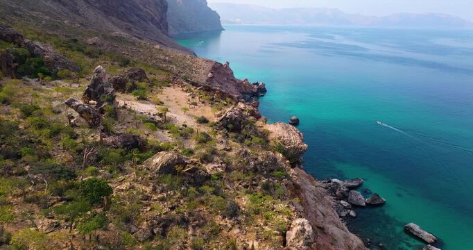 Rugged Cliffs At The Calm Waters Of Shoab Coast On Socotra Island In Yemen. Aerial Drone Shot