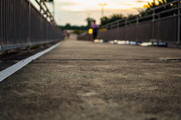 Group of people enjoying exercise on a public park bridge with fitness equipment, highlighting health, lifestyle, and background atmosphere in a vibrant outdoor space.