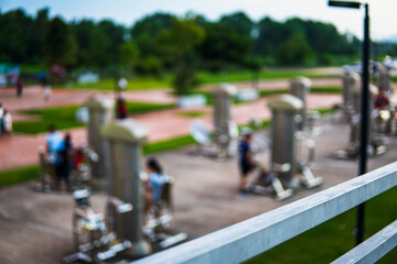 Obraz premium Group of people enjoying exercise on a public park bridge with fitness equipment, highlighting health, lifestyle, and background atmosphere in a vibrant outdoor space.