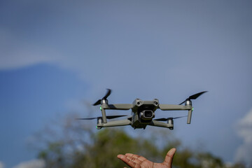Videography Drone Landing in Hand of Operator Outdoors