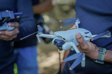 Holding a Videography Drone in Hand Outdoors Technology Concept