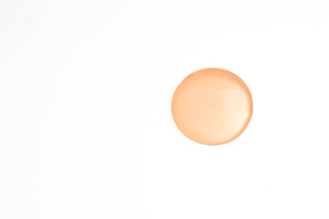 Makeup foundation swatch in beige tone, isolated on a clean white surface-ideal for demonstrating product consistency and skin tone compatibility.