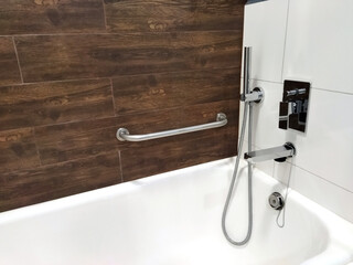 Bright bathroom features a modern bathtub and sleek fixtures