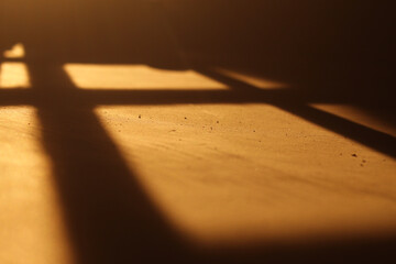 shadows on the wall when sunlight enters. The golden light creates aesthetic silhouettes and geometric patterns.