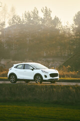 Fototapeta premium Electric car on scenic countryside route