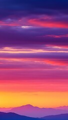 Fototapeta premium Beautiful sunrise over the mountains with vibrant colors in the sky and soft clouds above