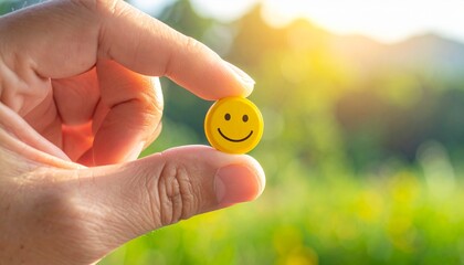 hand holding  a yellow smile icon