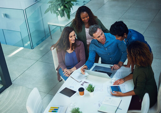 Charts, infographic and laptop with business people in office together for collaboration. Analytics, data and technology with social media team at work for discussion or project management from above