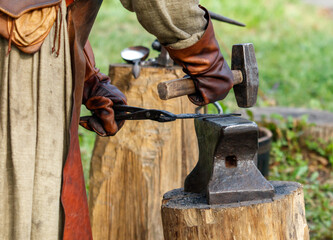 Man is hammering a piece of metal