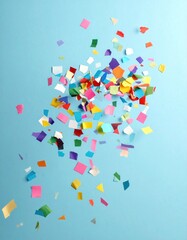 Colorful confetti scattered on a light-blue background