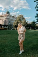 Fototapeta premium Woman with fluffy Pomeranian in city park