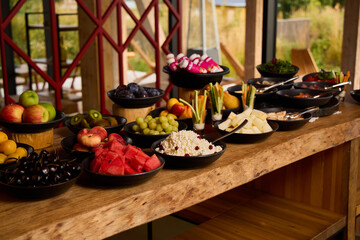 Colorful fruit and snack display at outdoor gathering location