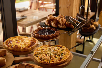 Delicious breakfast spread with quiches, pastries, and coffee