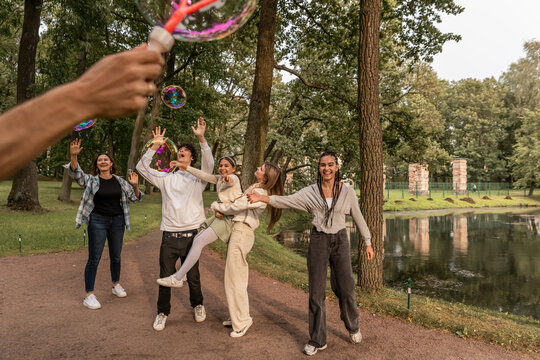People have fun with soap bubbles in nature.