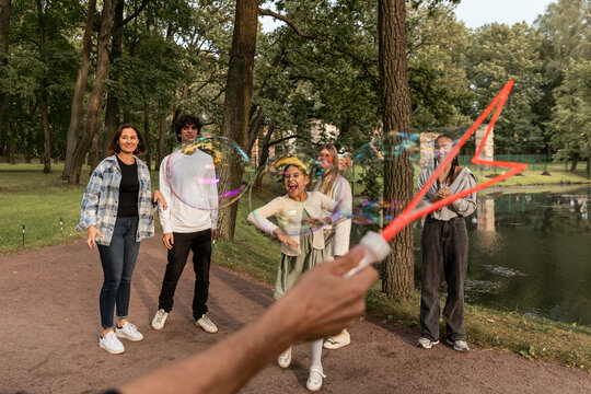 People have fun with soap bubbles in nature.