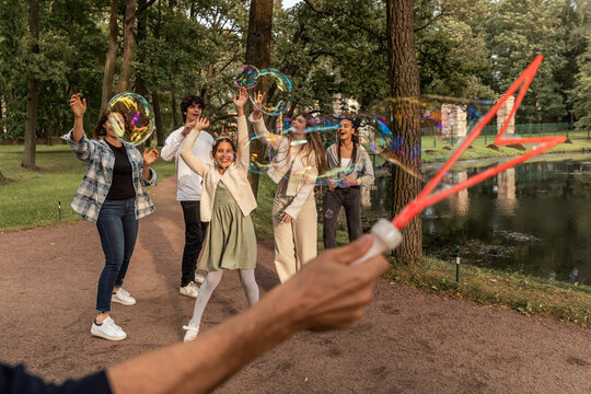 People have fun with soap bubbles in nature.