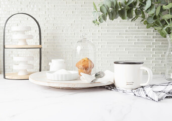 Bright airy countertop with mug, muffin, and bakery items