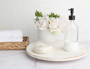 Light and airy feminine bathroom countertop in white bathroom