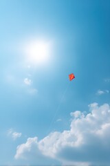 Kite caught in breeze high above, Sunshine and blue sky