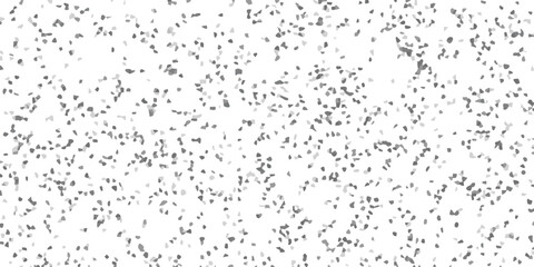 Abstract mosaic pattern of scattered irregular grey and light grey shapes on a white background texture