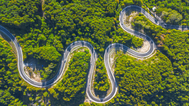 Aerial view of winding asphalt mountain road among green trees in summer. (Domani&ccedil;,İneg&ouml;l dağ yolu)	