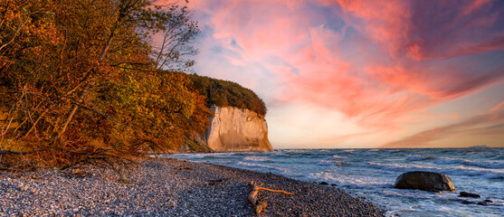 Chalk cliffs with a stone beach and colorful sunset on the island of Rügen on the Baltic Sea