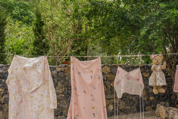 Different clothes drying on laundry line against garden background,clothes hanging laundry on washing line for drying towels drying on the clothesline.