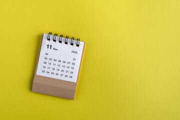 Hello, November 2025. A desktop calendar for planning on the table.