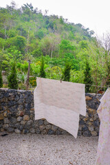 Different clothes drying on laundry line against garden background,clothes hanging laundry on washing line for drying towels drying on the clothesline.