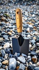 A small trowel rests on a bed of colorful pebbles