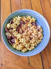 Colorful breakfast cereal with milk in a ceramic bowl