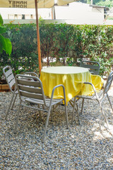 Colorful folding camping chair,wooden and chair set in garden on a sunny day,outdoor seating for restaurant or cafe.