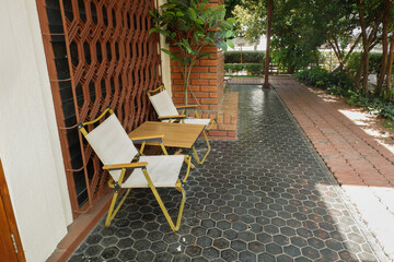Colorful folding camping chair,wooden and chair set in garden on a sunny day,outdoor seating for restaurant or cafe.